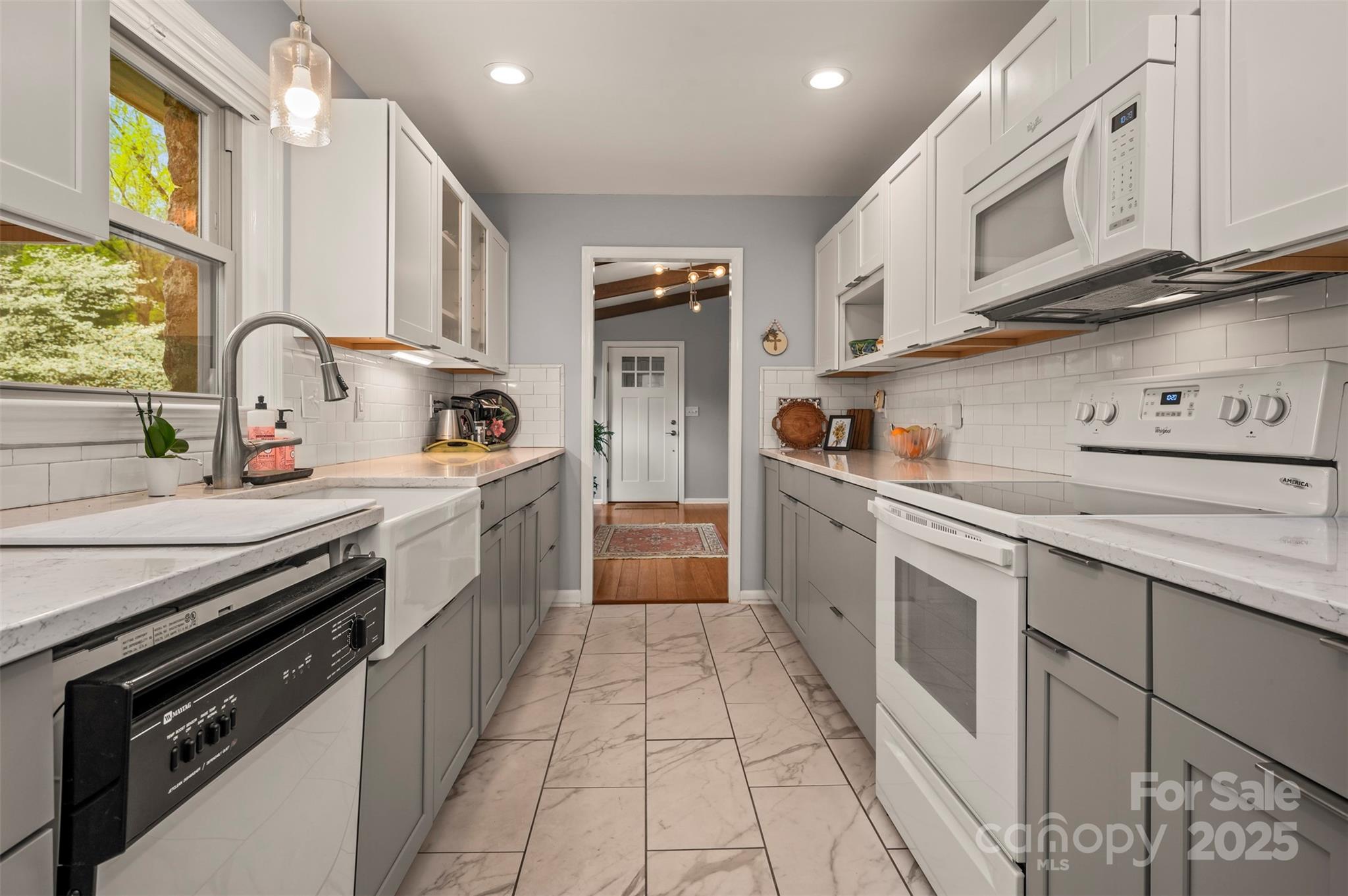 44 Jervey Road, Unit 3A Tryon, NC 28782 - Photo 14 of 29 a kitchen with stainless steel appliances granite countertop a stove a sink and a refrigerator