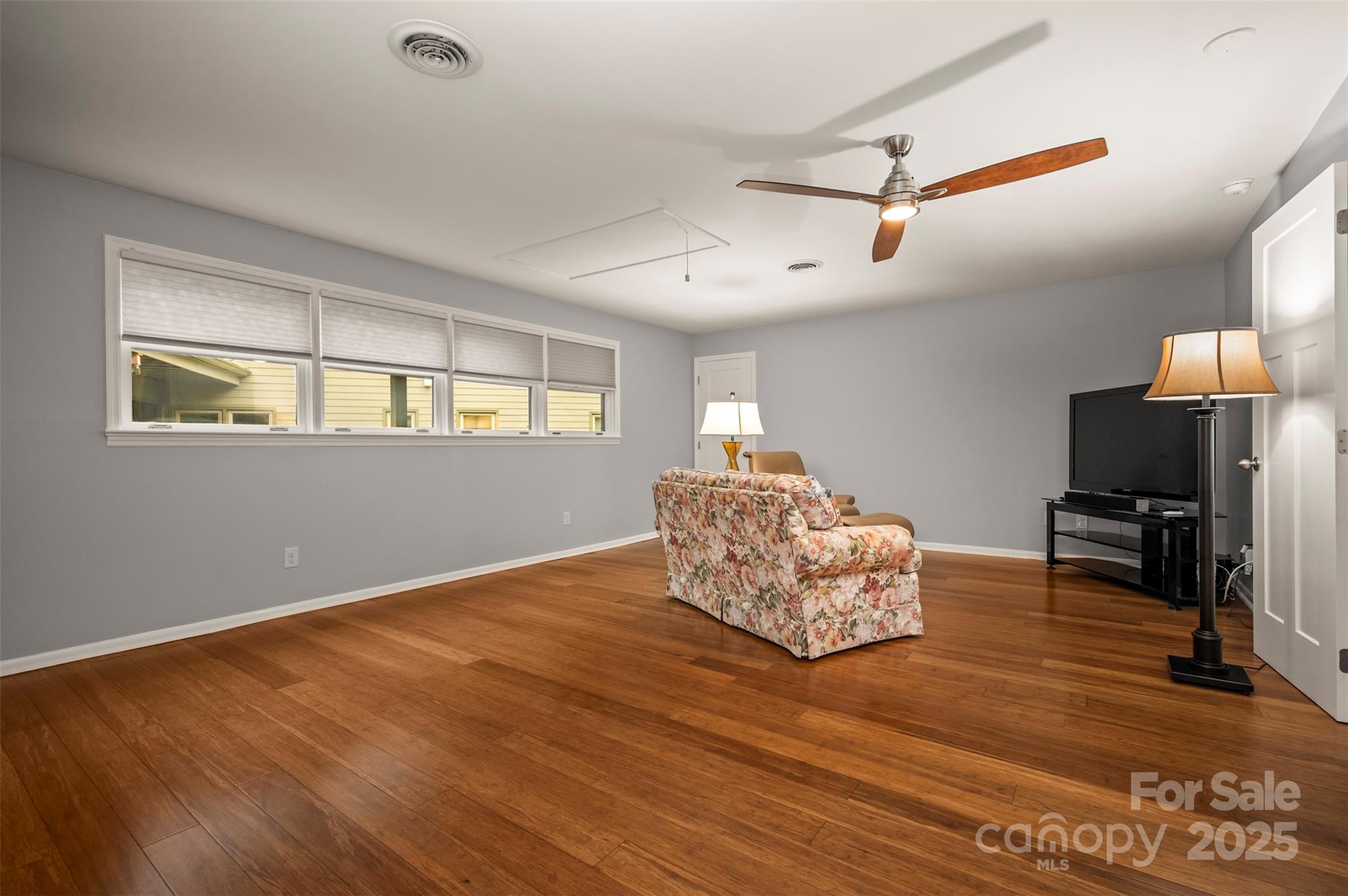 44 Jervey Road, Unit 3A Tryon, NC 28782 - Photo 18 of 29 a living room with hard wood floors and a ceiling fan