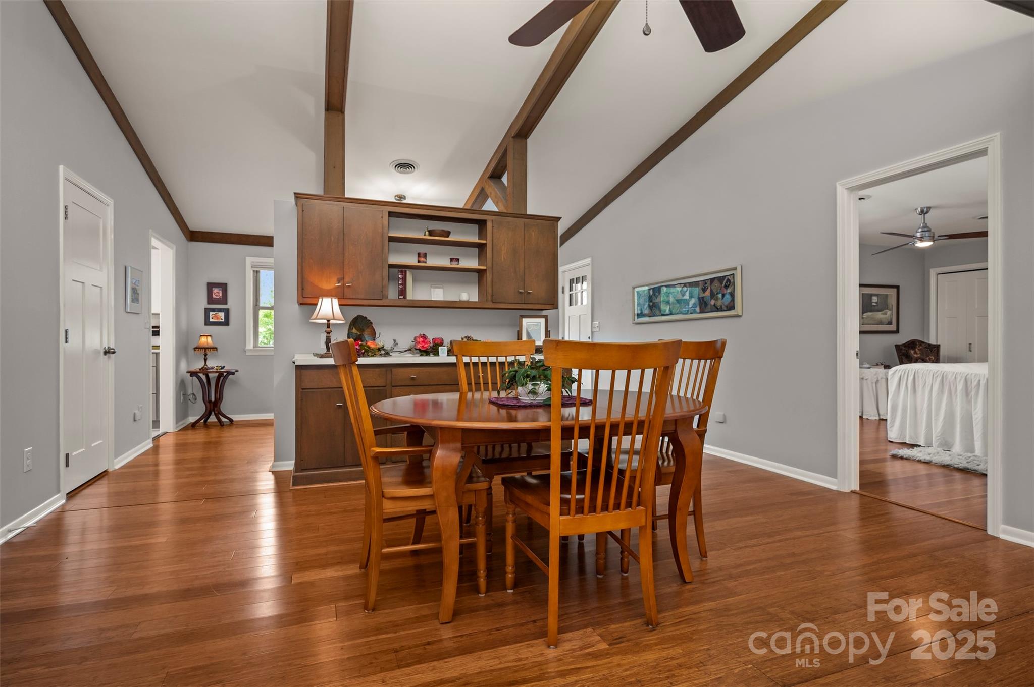 44 Jervey Road, Unit 3A Tryon, NC 28782 - Photo 5 of 29 a dining room with furniture wooden floor a rug a painting and a chandelier