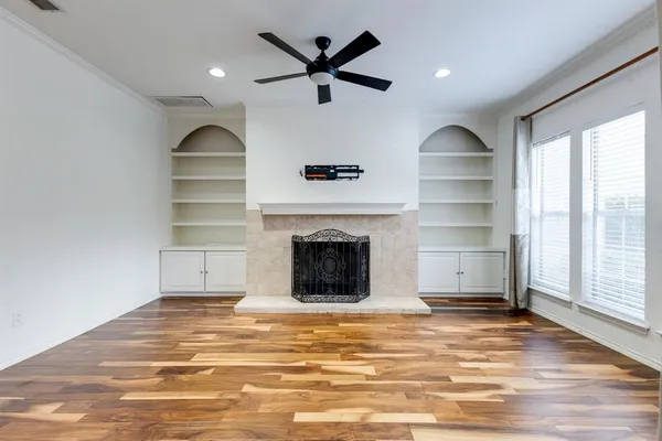 a view of a livingroom with a fireplace and window