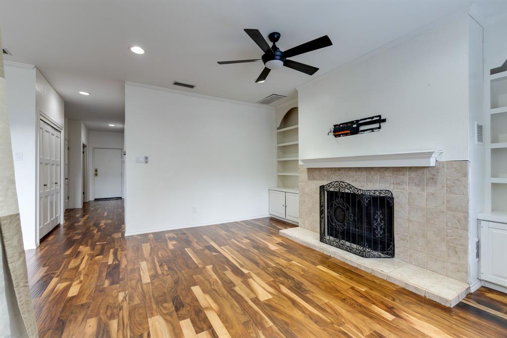 5310 Keller Springs Road, Unit 413 Dallas, TX 75248 - Photo 12 of 20 a view of a livingroom with a fireplace a ceiling fan and entryway