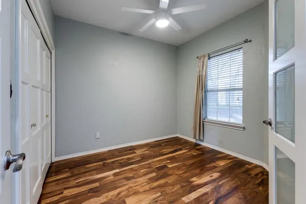a view of a room with a large window and front view of a house