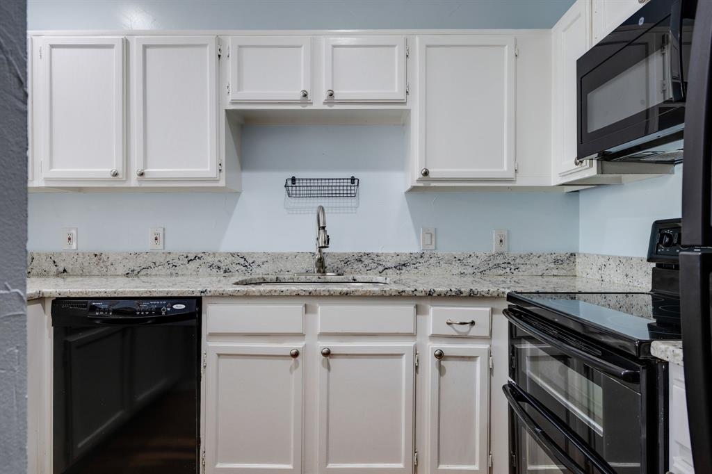 5310 Keller Springs Road, Unit 413 Dallas, TX 75248 - Photo 4 of 20 a kitchen with granite countertop white cabinets and a sink