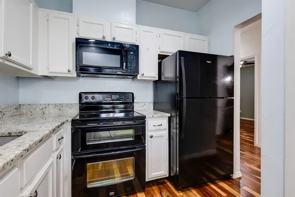 a kitchen with a refrigerator stove and microwave