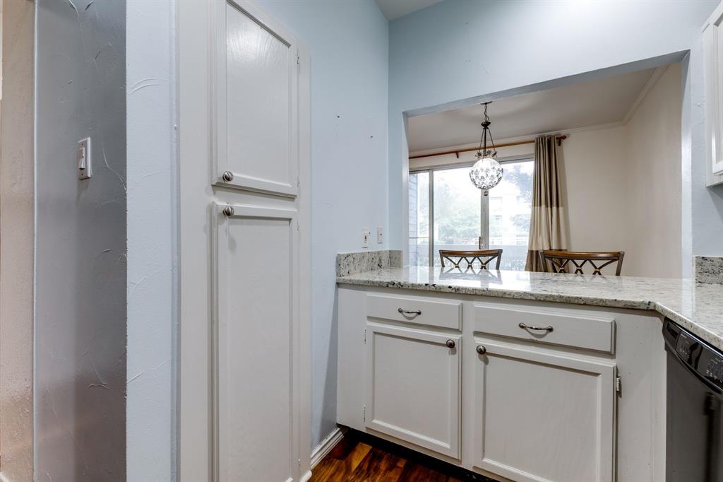 5310 Keller Springs Road, Unit 413 Dallas, TX 75248 - Photo 6 of 20 a kitchen with white cabinets and white appliances