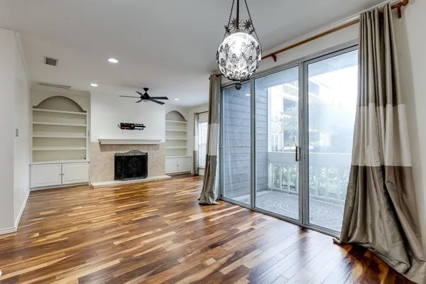 a view of room with wooden floor and ceiling fan