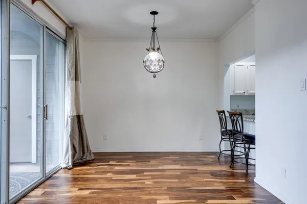 a view of a room with wooden floor and a fireplace