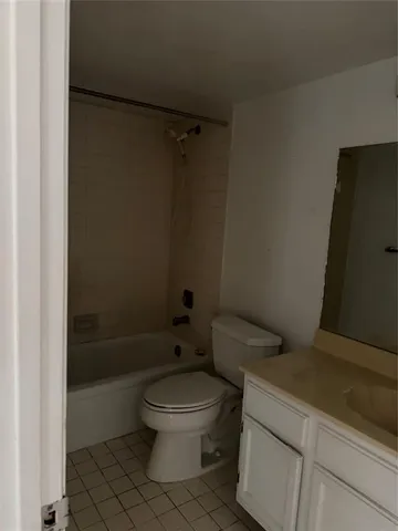 a white toilet sitting next to a bath tub and a shower