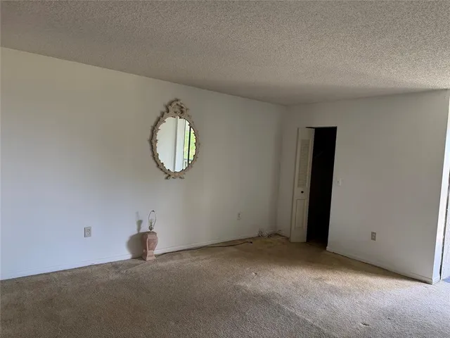 a view of a room with a hanging light and kitchen