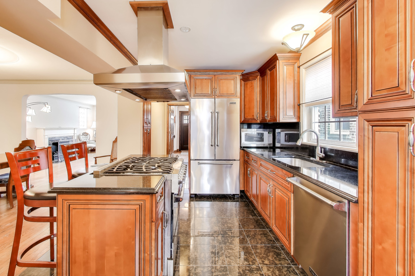 6230 North Troy Street Chicago, IL 60659 - Photo 11 of 38 a kitchen with stainless steel appliances granite countertop a refrigerator a stove and a sink