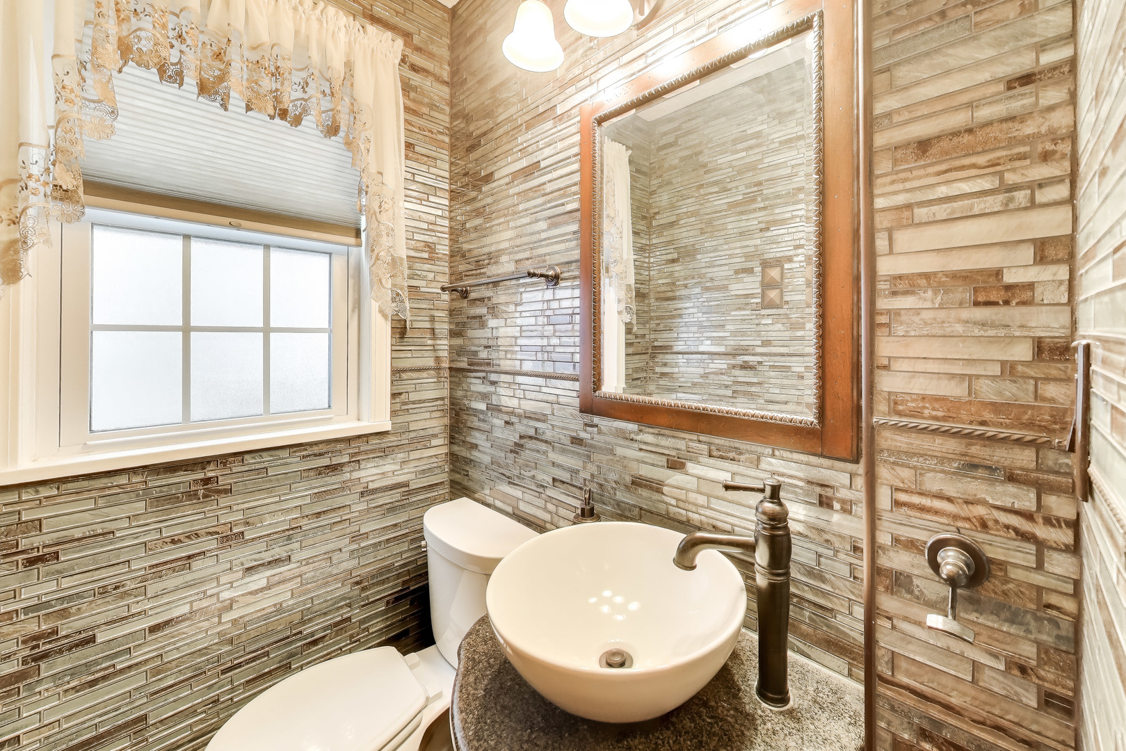 6230 North Troy Street Chicago, IL 60659 - Photo 15 of 38 a bathroom with a toilet a sink and mirror