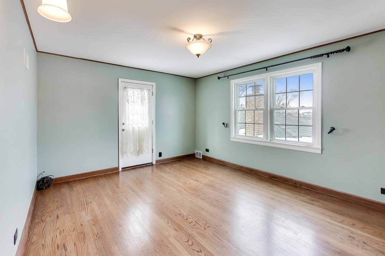 6230 North Troy Street Chicago, IL 60659 - Photo 16 of 38 an empty room with wooden floor and windows