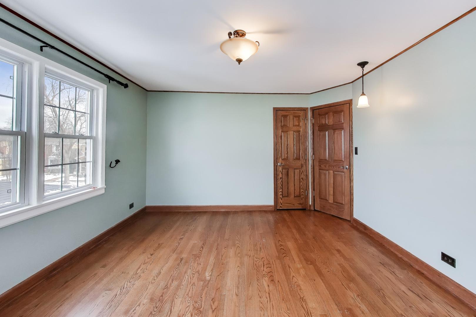 6230 North Troy Street Chicago, IL 60659 - Photo 17 of 38 a view of an empty room with window and wooden floor