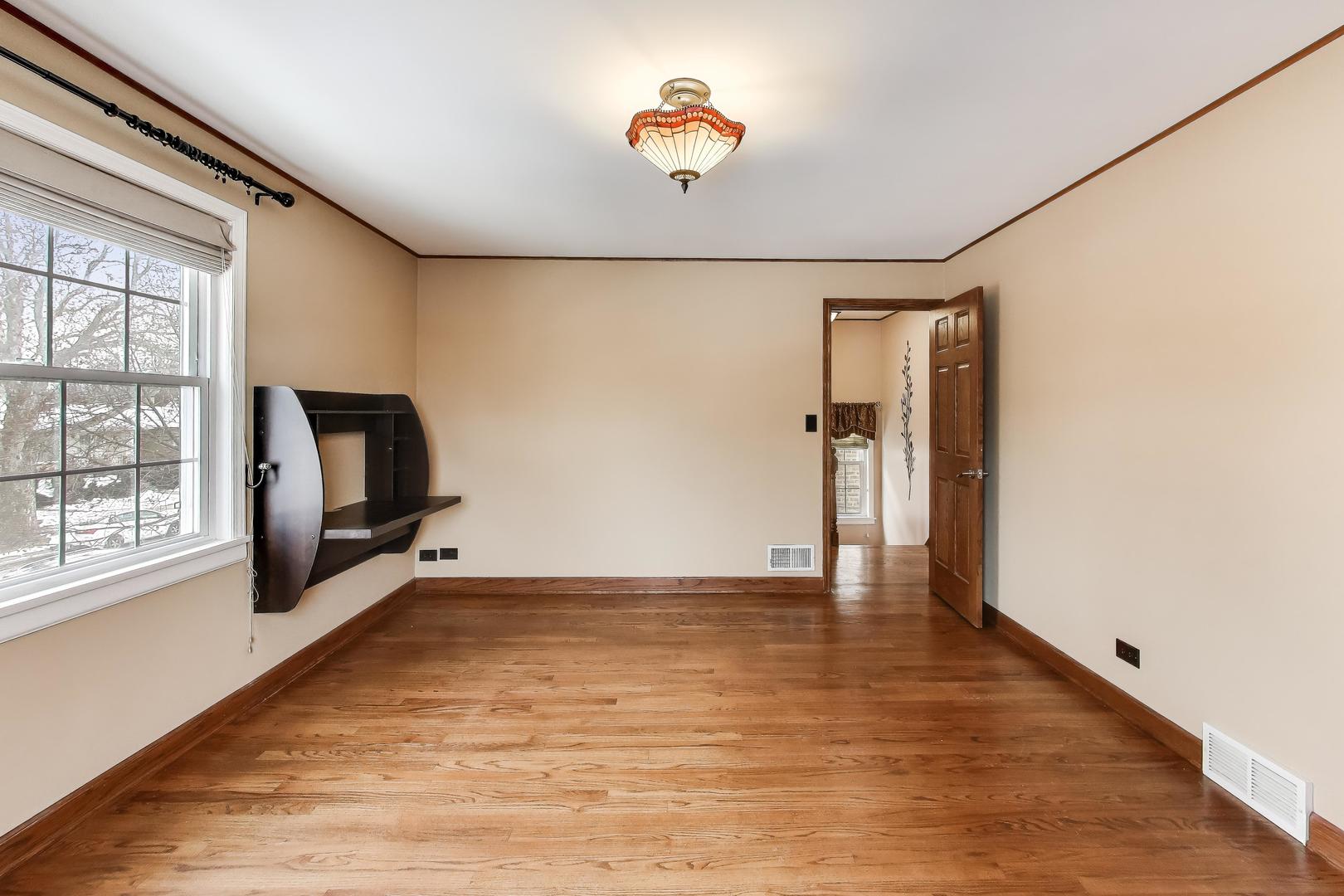 6230 North Troy Street Chicago, IL 60659 - Photo 19 of 38 a view of an empty room with wooden floor and a window