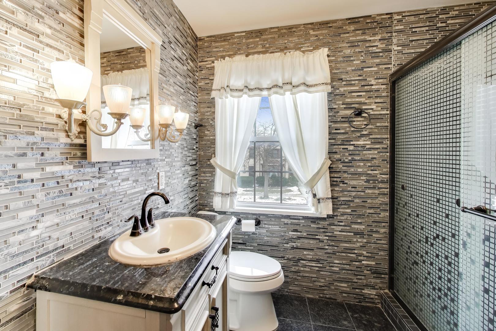 6230 North Troy Street Chicago, IL 60659 - Photo 22 of 38 a bathroom with a sink a toilet and a shower