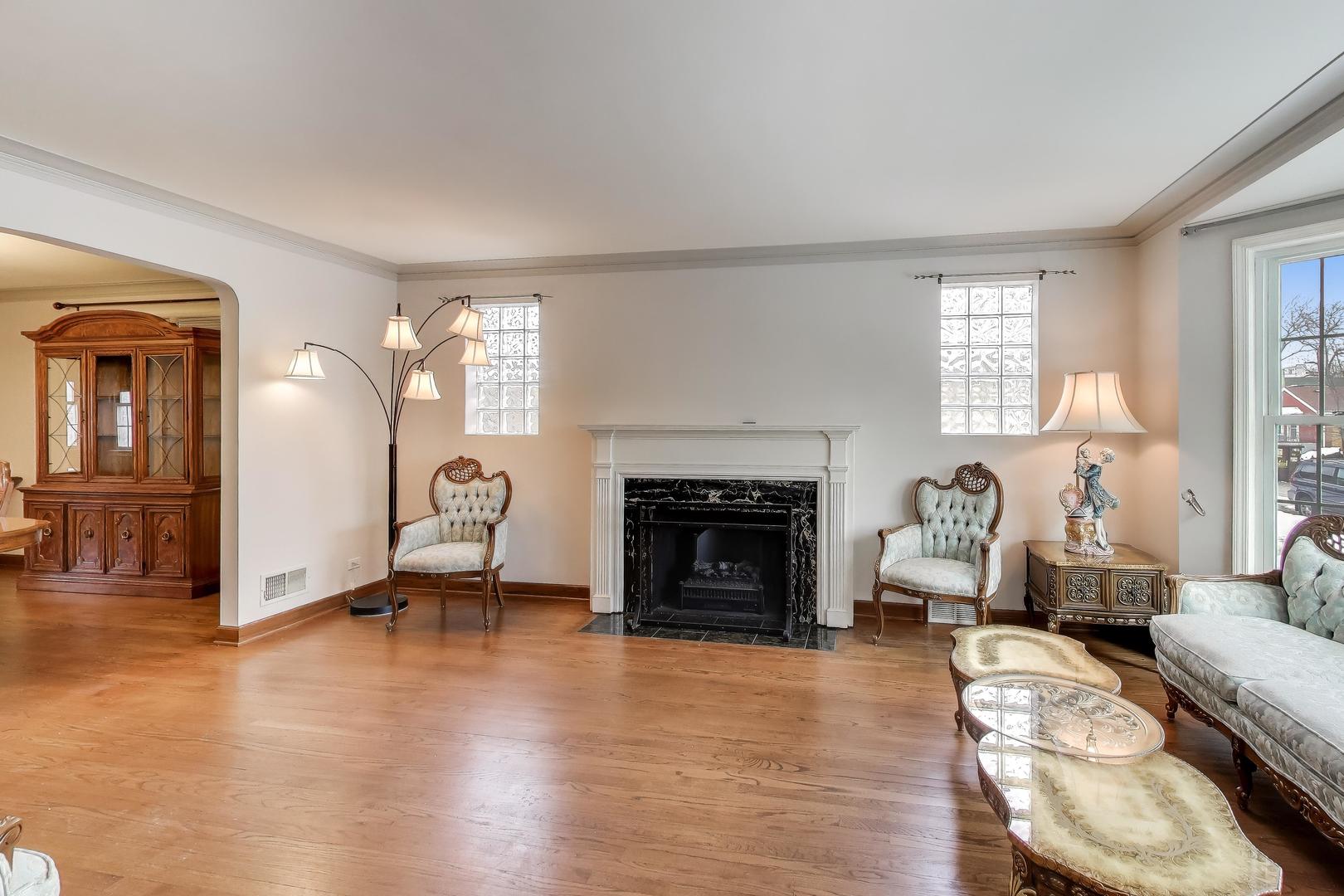 6230 North Troy Street Chicago, IL 60659 - Photo 5 of 38 a living room with furniture and a fireplace