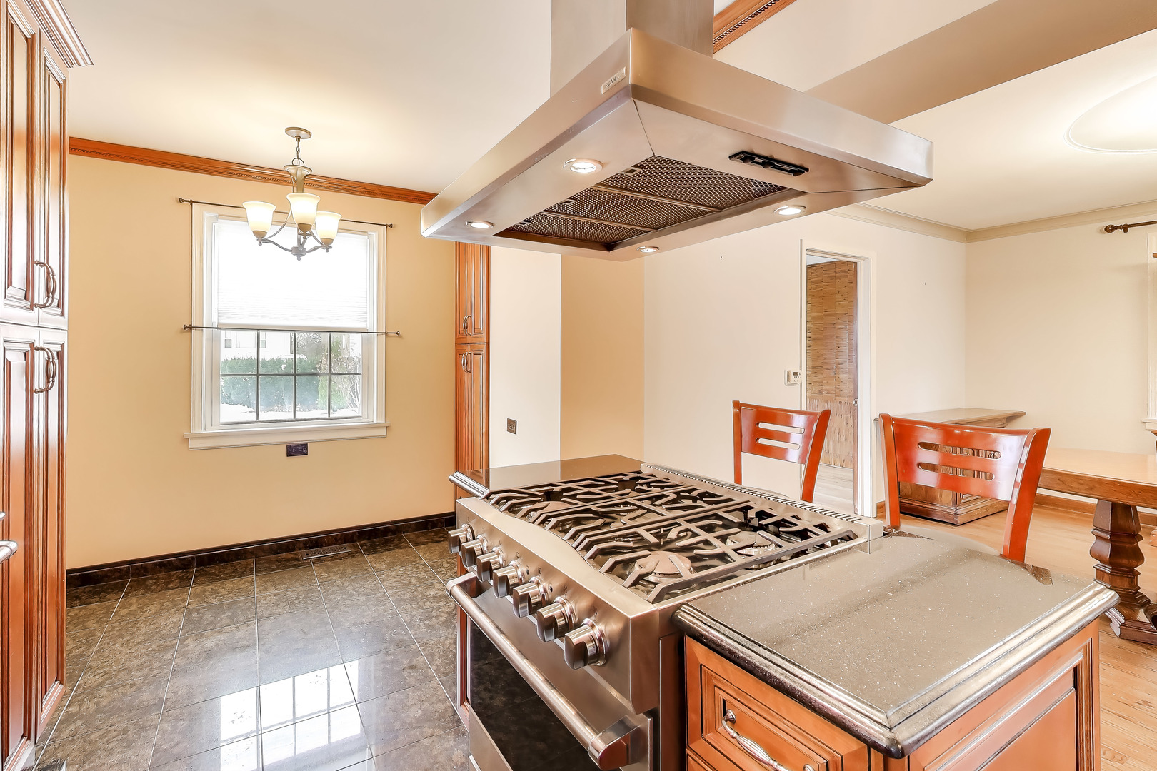 6230 North Troy Street Chicago, IL 60659 - Photo 9 of 38 a kitchen that has a stove and a table