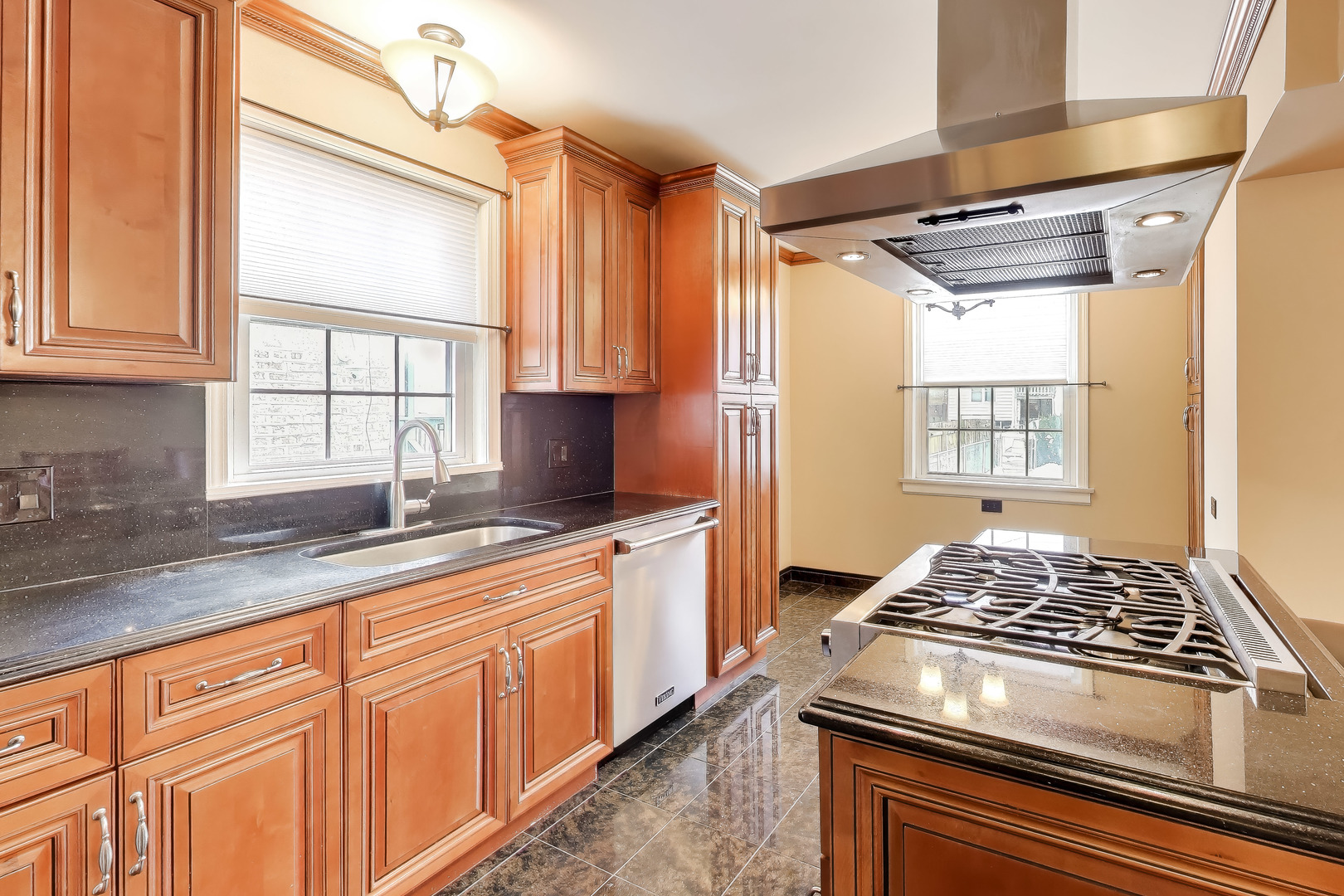 6230 North Troy Street Chicago, IL 60659 - Photo 10 of 38 a kitchen with stainless steel appliances granite countertop a sink stove and cabinets