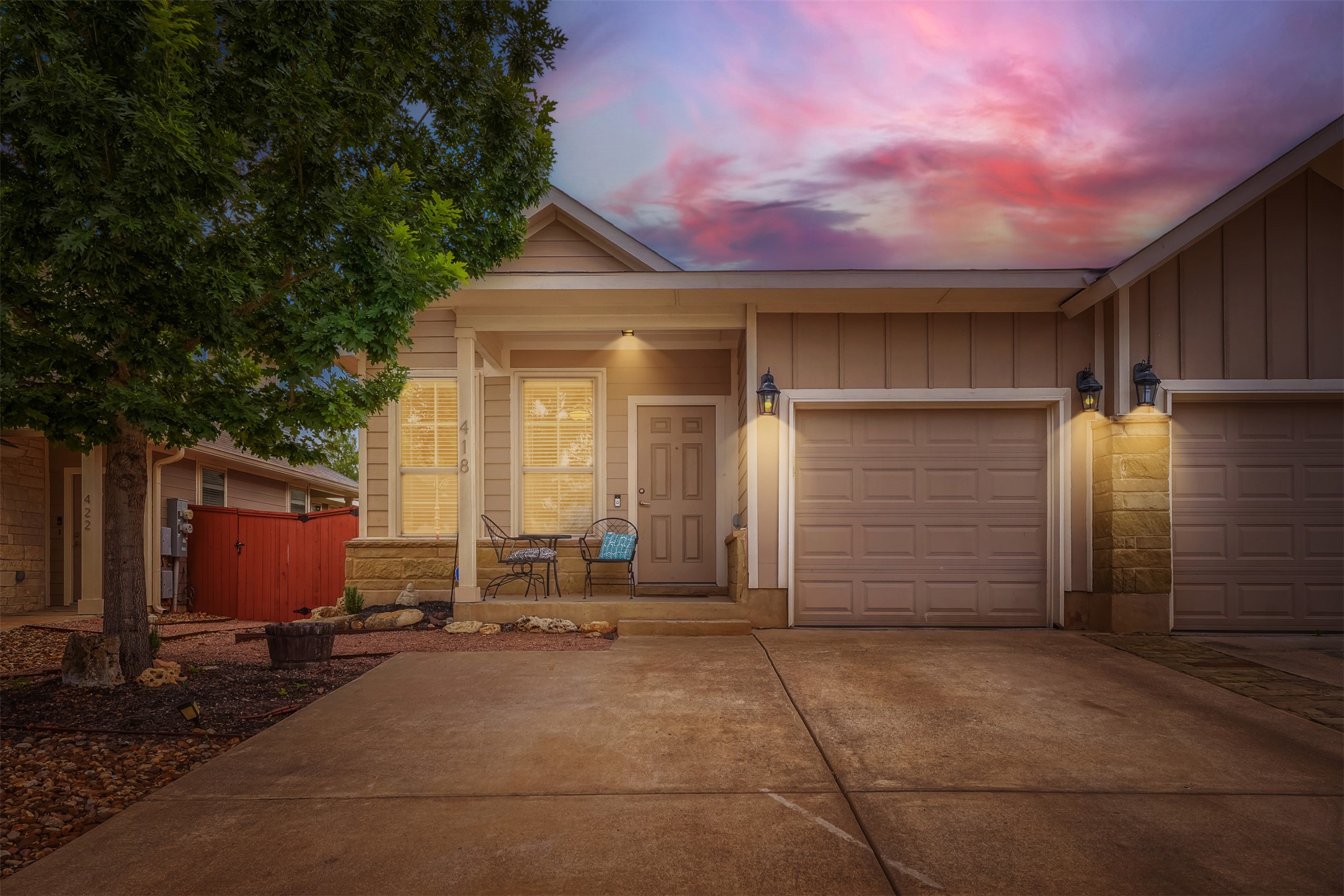 418 High Tech Drive Georgetown, TX 78626 - Photo 29 of 34 Inviting front exterior featuring a covered porch, two-car garage, and stone accents