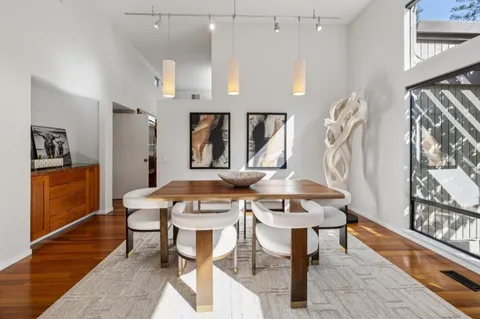 a view of a dining room with furniture and wooden floor