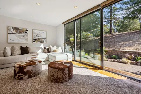 a living room with furniture and a floor to ceiling window