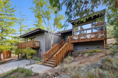 a view of house with outdoor space and sitting area