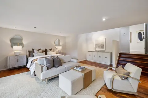 a spacious bedroom with a bed and couch