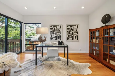 a spacious bedroom with a bed and glass door