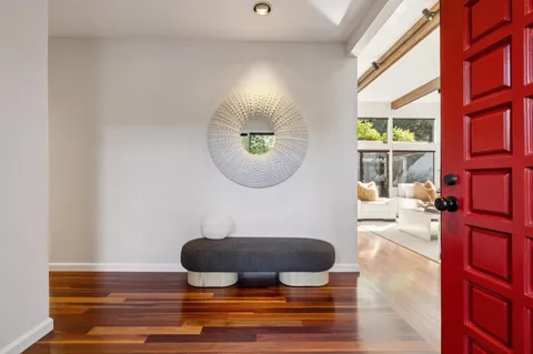 a living room with furniture and a mirror