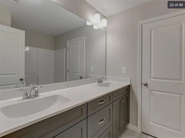 a bathroom with a sink double vanity and a mirror