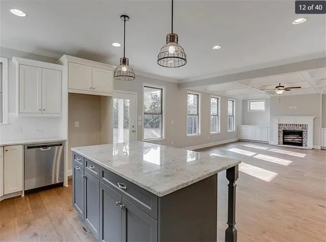 a kitchen with stainless steel appliances granite countertop a kitchen island a stove and a sink