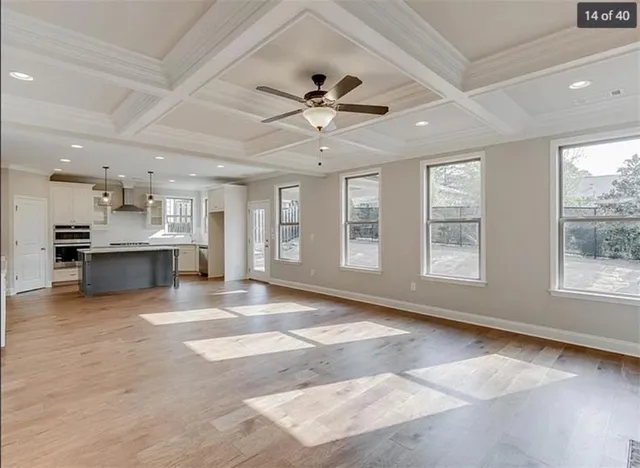a view of an empty room with window and cabinet