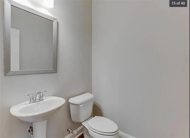a bathroom with a sink a toilet and mirror