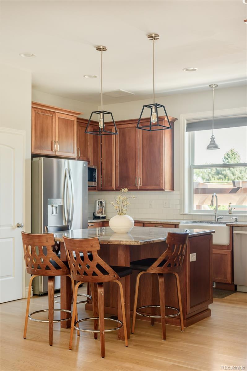 3234 Stuart Street Denver, CO 80212 - Photo 12 of 41 a view of a dining room with furniture window and wooden floor