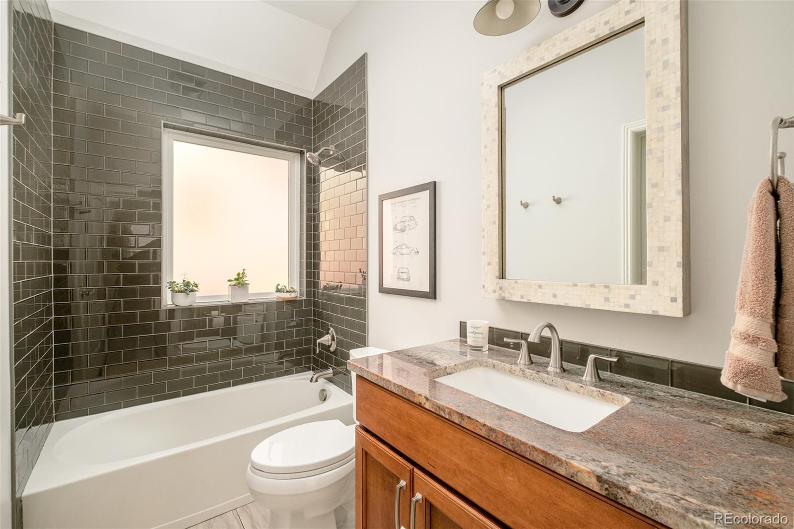 3234 Stuart Street Denver, CO 80212 - Photo 14 of 41 a bathroom with a granite countertop sink toilet mirror and bathtub