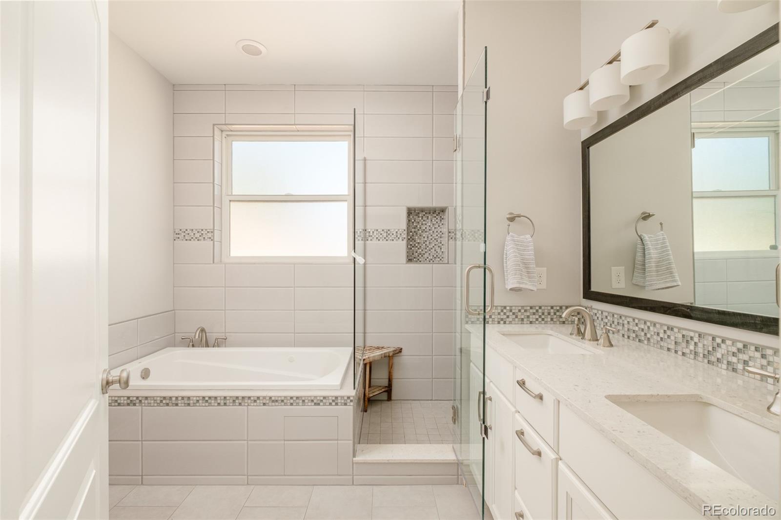 3234 Stuart Street Denver, CO 80212 - Photo 21 of 41 a spacious bathroom with a granite countertop tub sink and mirror