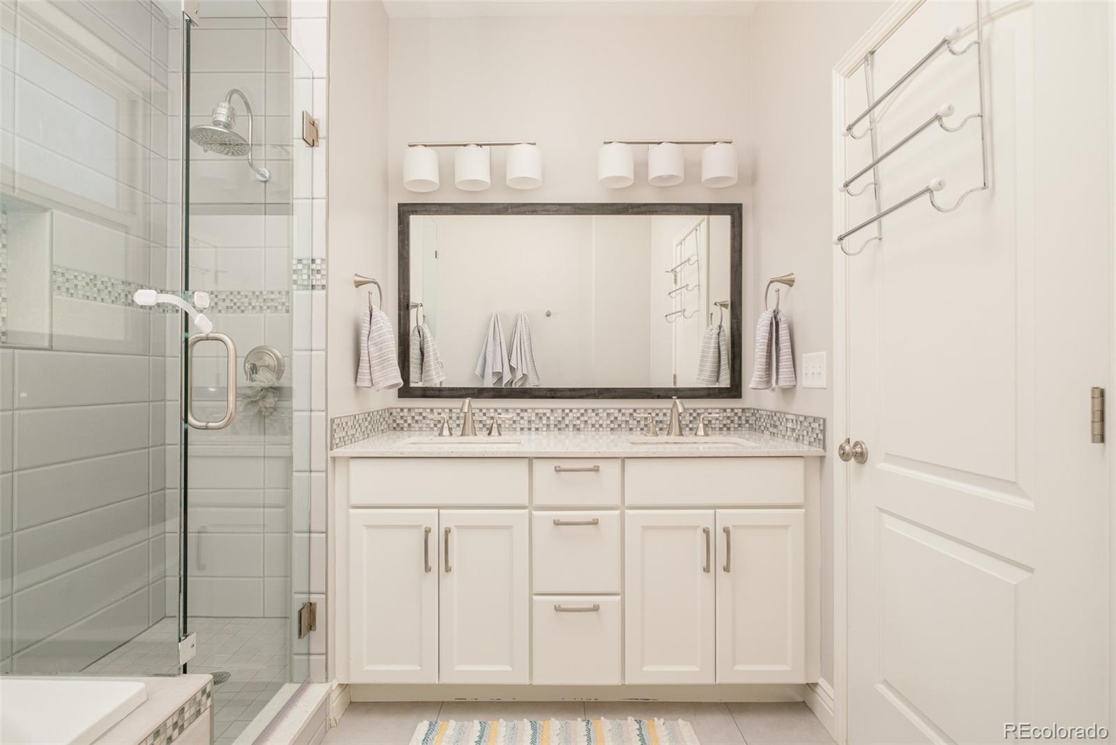 3234 Stuart Street Denver, CO 80212 - Photo 22 of 41 a bathroom with a granite countertop shower sink and mirror