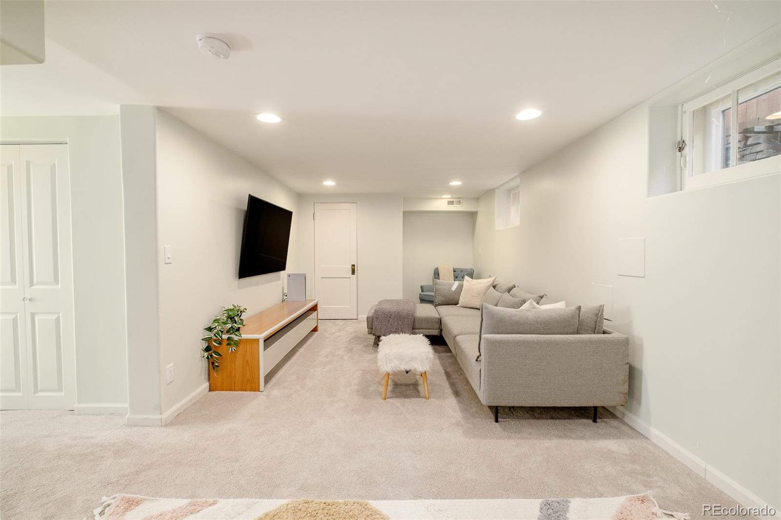 3234 Stuart Street Denver, CO 80212 - Photo 26 of 41 a living room with couches and a flat screen tv