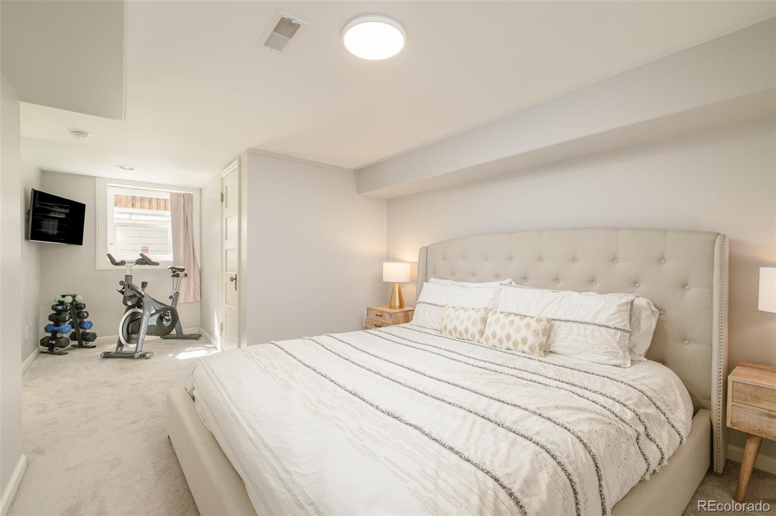 3234 Stuart Street Denver, CO 80212 - Photo 27 of 41 a bedroom with a bed and a tv