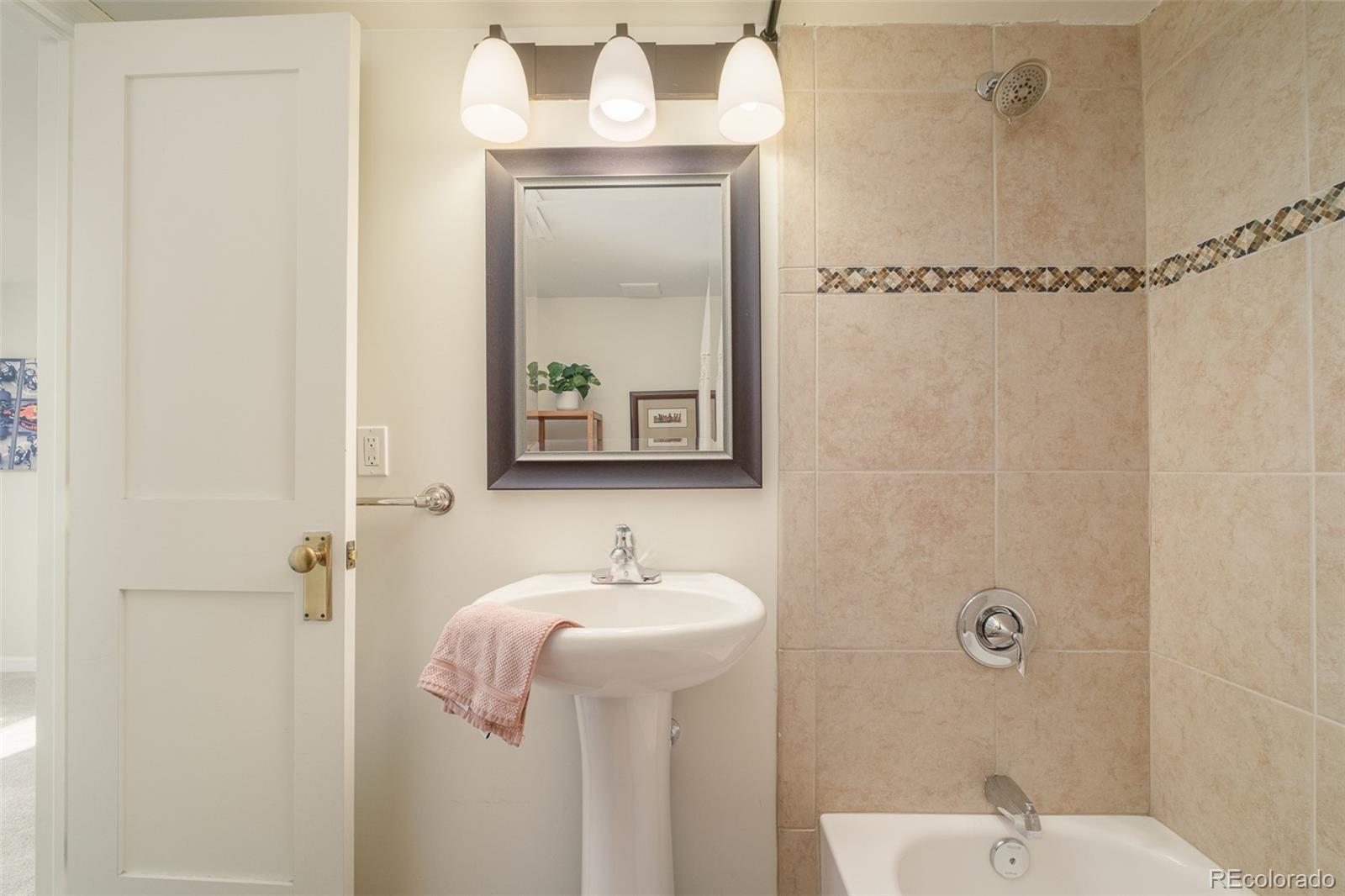 3234 Stuart Street Denver, CO 80212 - Photo 28 of 41 a bathroom with a shower a sink and mirror
