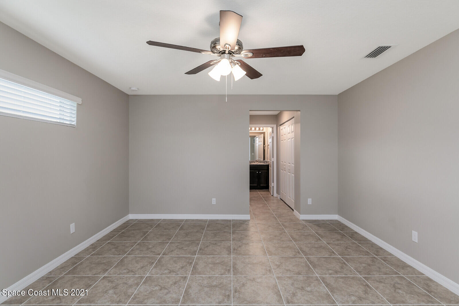 428 Scarlet Road Southwest Palm Bay, FL 32908 - Photo 14 of 35 a view of an empty room and window and chandelier fan