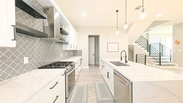 a kitchen with a sink stove and cabinets