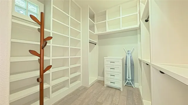 a view of walk in closet with empty racks