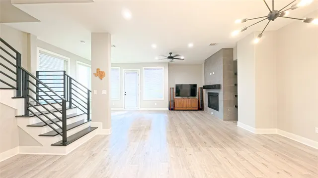 a view of a kitchen with furniture and wooden floor