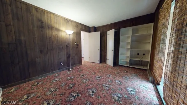 a view of a big room with closet and front door