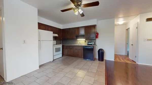 a kitchen with stainless steel appliances a refrigerator and a stove top oven