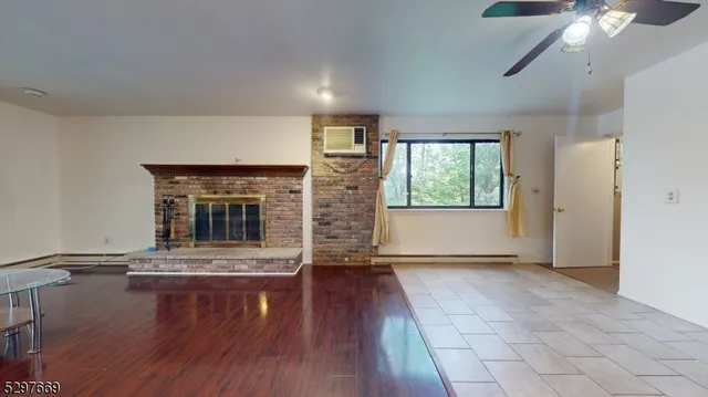 wooden floor fireplace and natural light in room