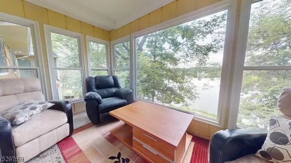 a living room with furniture and a floor to ceiling window