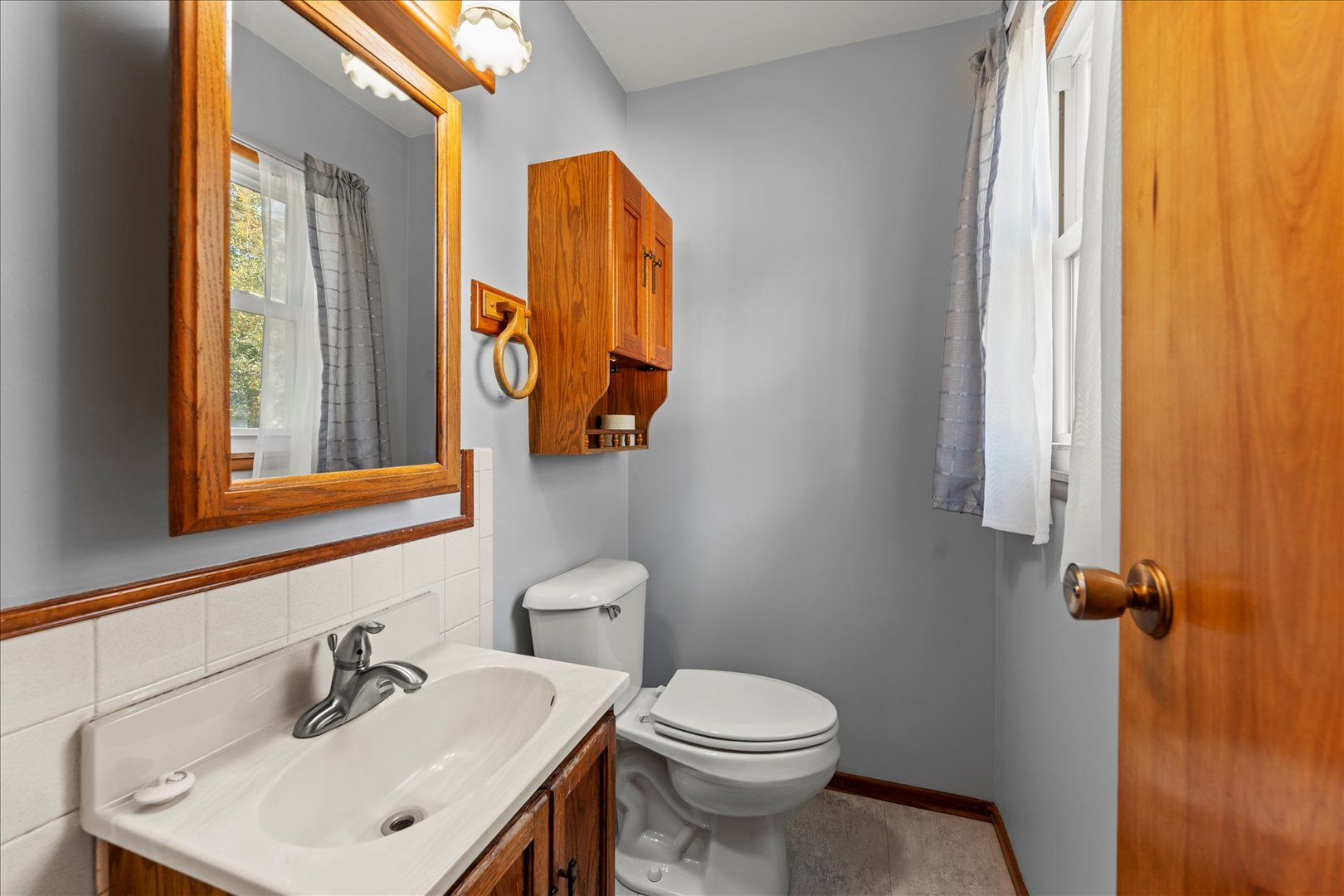 708 Jackson Street Monticello, IL 61856 - Photo 15 of 28 a bathroom with a sink and mirror with toilet