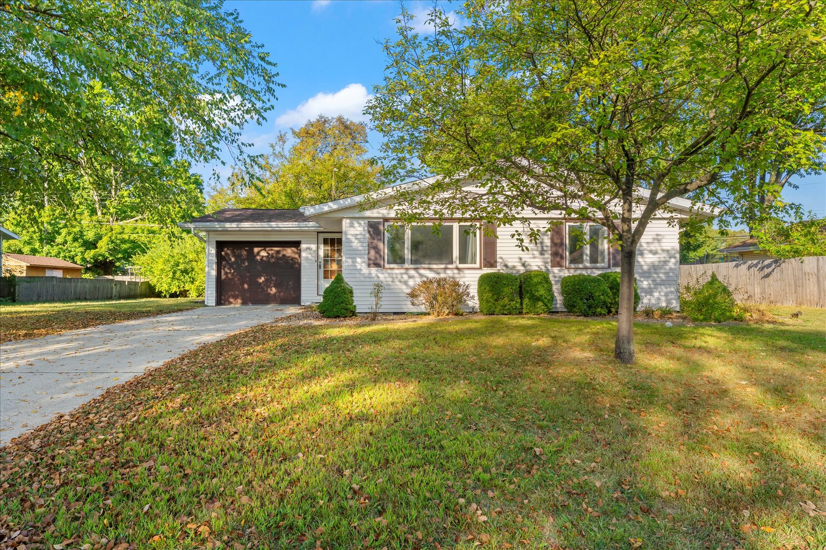 708 Jackson Street Monticello, IL 61856 - Photo 2 of 28 a front view of a house with a yard and a garage